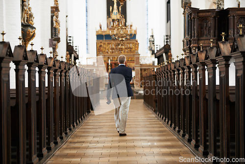 Image of Walking, aisle and senior man in a church for sightseeing on a weekend trip, vacation or holiday. Faith, religion and back of holy elderly male person in retirement in worship cathedral in the city.