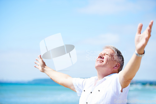 Image of Beach, freedom and happy senior man with open arms in nature for travel, adventure or celebration. Ocean, smile and elderly male person with retirement vacation at the sea with gratitude in Bali