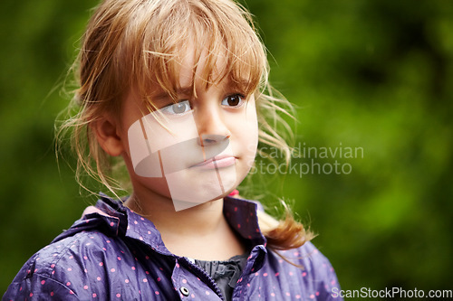 Image of Girl, child and thinking outdoor with sad, raincoat and decision or choice to play in rain weather. Person, kid and emoji with disappointed expression, annoyed or moody in nature or backyard garden