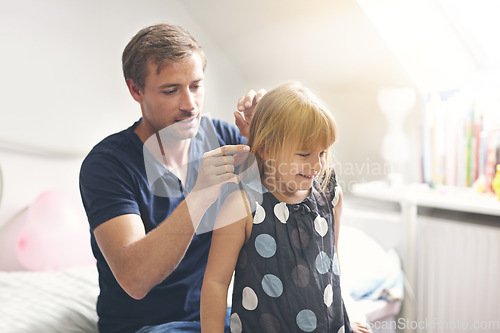 Image of Father, daughter and helping with hair or happiness on bed in bedroom of home for support and love. Family, man and girl child with smile, hairstyle and haircare for parenting, care and relationship