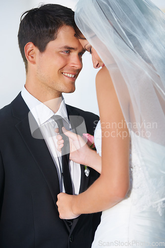 Image of Love, wedding or romance with a bride and groom in studio on a white background for celebration at a marriage event. Smile, commitment or loyalty with a happy couple getting married as newlyweds