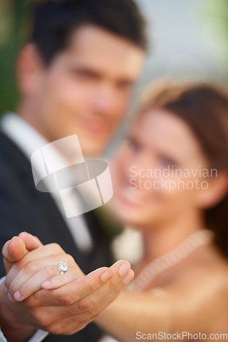 Image of Hands, ring and a couple on their wedding day for love, romance or celebration at a marriage ceremony. Trust, commitment or promise with a bride and groom together at an event to get married closeup