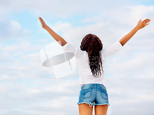 Image of Woman, back and excited with arms in air with travel, vacation of winner happy from holiday. Winning, African person and blue sky with joy from gratitude, achievement and freedom with break outdoor