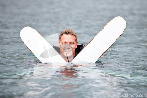 Image of Man, water ski and portrait in lake, smile and waiting for tow with fitness, extreme sports or exercise. Person, happy and outdoor in river, nature and float with swimming, health and summer training