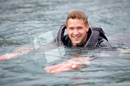 Image of Man, water ski and portrait in lake, happy and waiting for tow with fitness, extreme sports or exercise. Person, smile and outdoor in river, nature and float with swimming, health and summer training