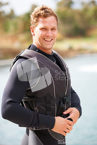 Image of Man, ready and life jacket at lake, summer or portrait for extreme sports for fitness, exercise or workout. Person, happy and safety vest by river, nature or smile for pride, health or start training