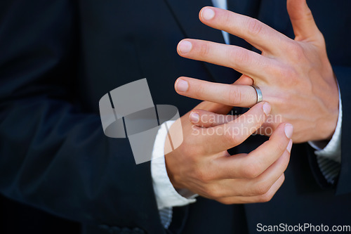 Image of Man, groom and hands with ring for marriage, commitment or symbol of love, trust or care. Closeup of married male person in suit adjusting jewelry on finger for vow, promise or wedding engagement