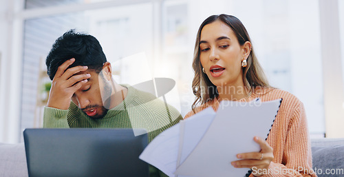 Image of Couple, bills and stress in home for debt, poor budget and financial mistake of mortgage loan, taxes or rent. Frustrated man, woman and finance documents at laptop for bankruptcy, inflation or crisis
