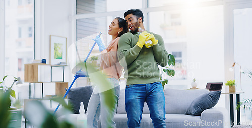Image of Happy couple, dancing and singing while cleaning living room together for fun disinfection or hygiene at home. Man and woman enjoying housekeeping, germ and bacteria removal in lounge at house