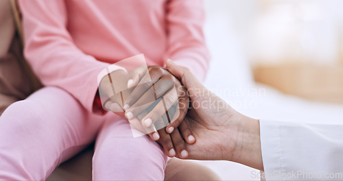 Image of Closeup, holding hands and doctor with girl, healthcare and wellness with comfort, diagnosis and support. People, medical and professional with a patient, compassion and empathy with paediatrician