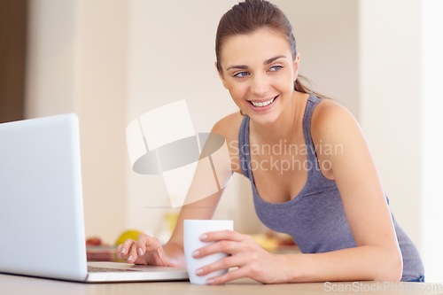 Image of Laptop, coffee and smile with a woman thinking in the kitchen of her home in the morning for education. Computer, idea and research with a happy young person typing an email for communication