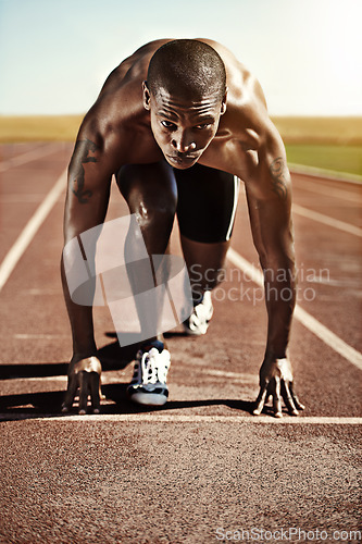 Image of Portrait, man and ready for race, track and field with practice for competition. Olympics, male runner or athlete with determination on face for sprint, performance or sport by commitment for fitness