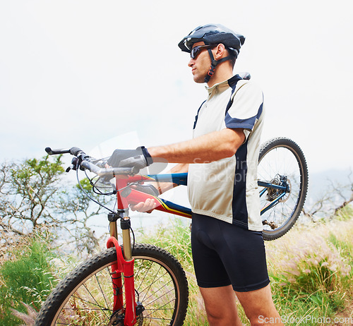 Image of Sports, bike and fitness with a man in the mountains for cardio training, recreation or a summer hobby. Nature, cycling and freedom with a confident young athlete outdoor for eco friendly exercise