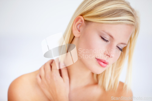 Image of Woman, skincare and beauty with eyes closed in studio for wellness, care or health by white background. Girl, model and peace with touch for skin, cosmetic change and transformation with natural glow