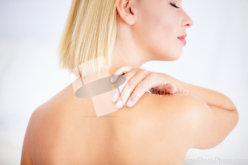Image of Woman, skincare and touch shoulder in studio with back, eyes closed and beauty by white background. Girl, model and blonde with smooth skin, cosmetic change and transformation with glow for wellness