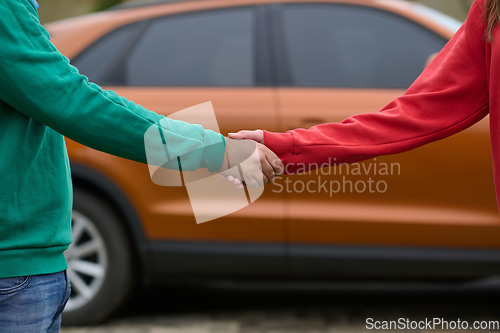 Image of Car keys handshake, seller or car salesman and customer in a dealership, shake hands over the car keys