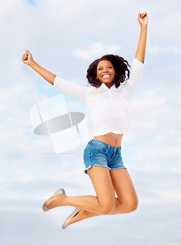 Image of Black woman, jumping and excited in air with travel, vacation of winner happy from holiday. Winning, African person and leap with joy from celebration, achievement and freedom outdoor with smile