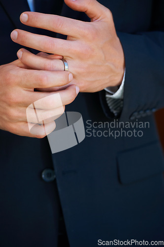 Image of Groom, hand closeup and ring for marriage, ceremony or celebration in suit, fingers and event. Person, palm and metal jewelry for wedding, party or commitment to relationship, engagement or proposal