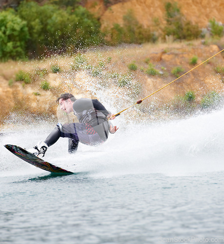 Image of Trick, wakeboarding and adventure, man on lake with outdoor fun, fitness and wave splash. Balance, water sports and person on river with freedom, speed and energy for surfing challenge, ski and sun.