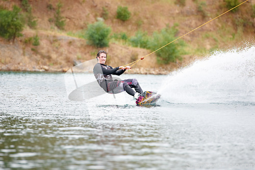 Image of Nature, wakeboarding and adventure, man on lake with outdoor fun, fitness and wave splash. Balance, water sports and person on river with freedom, speed and energy for surfing challenge, ski and sun.