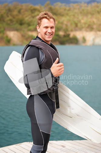 Image of Lake, thumbs up and portrait of man with wakeboard for surfing, exercise and hobby outdoors. Fitness, extreme sports and person with emoji and board for water skiing for freedom, adventure and fun