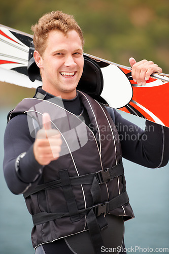 Image of Sports, thumbs up and portrait of man with wakeboard for surfing, exercise and recreation hobby by lake. Fitness, emoji hand sign and person with board for water skiing for freedom, adventure and fun