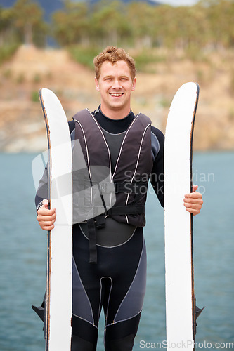 Image of Lake, ski and portrait of man with wakeboard for surfing, exercise and recreation hobby outdoors. Fitness, extreme sports and happy person with board for water skiing for freedom, adventure and fun