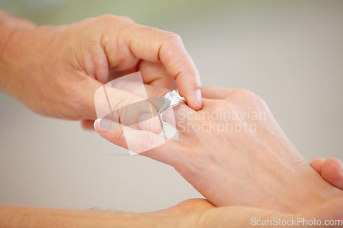 Image of People, hands and wedding ring for marriage, love or commitment together in promise at ceremony. Closeup of married groom putting diamond jewelry or accessory on bride for engagement, romance or care