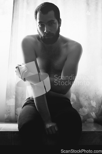 Image of Man, bedroom and portrait with thinking and creativity with black and white and beard at home. Art, shadow and male model sitting in a house with a problem and lonely from grief and monochrome