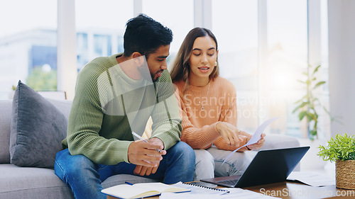 Image of Laptop, documents and couple on sofa for taxes, online banking and budget payment. Living room, home and man and woman help with paperwork, bills and computer for insurance, savings and finances