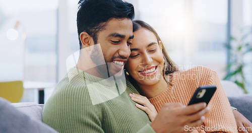 Image of Couple, phone and smile in living room for social media, reading notification or scroll with online shopping app at home. Happy man, interracial woman and smartphone to search digital news on website