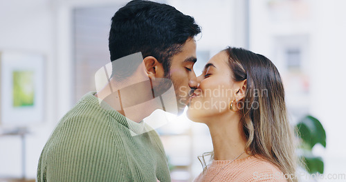 Image of Love, kiss and couple in a house with care, trust or security, bond or happy relationship moment. Passion, date or people in a living room with respect, gratitude or soulmate connection at home