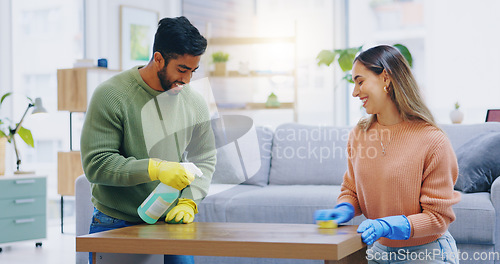 Image of Couple, spray and cleaning in home of table, furniture and disinfection of dust, dirt or risk of bacteria. Happy man, interracial woman and bottle of chemical detergent to wipe surface in living room