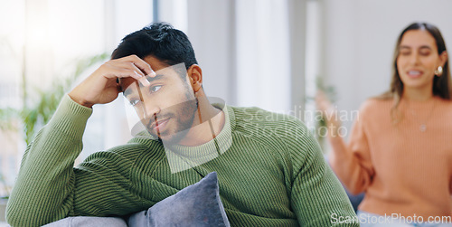 Image of Couple, home and fight on sofa, sad and angry with stress, mental health and headache with relationship crisis. Man, woman and together on lounge couch with conflict, anxiety and mistake in marriage