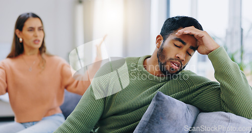 Image of Couple, home and fight on couch, sad and angry with stress, mental health and headache with relationship crisis. Man, woman and questions on lounge sofa with conflict, anxiety and mistake in marriage