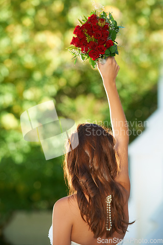 Image of Woman, back and wedding rose bouquet with love, commitment and trust ceremony for marriage. Engagement, celebration and flowers for event in a park with a red floral plant and bride dress outdoor