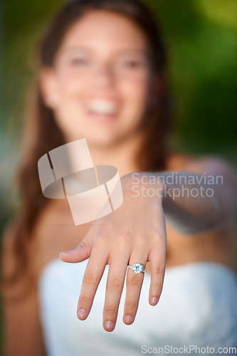 Image of Bride, woman and hand with wedding ring outdoor for marriage, commitment and celebration with diamond. Love, unity and person in nature with jewelry for ceremony, smile and support on park in summer