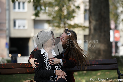 Image of Elderly old cute woman with Alzheimer's very happy and smiling when eldest daughter hugs and takes care of her