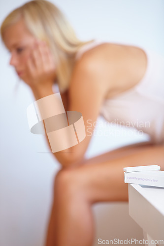 Image of Anxiety, worry and woman with pregnancy test in bathroom waiting for results, news and information. Motherhood, pregnant and sad person with medical testing kit for fertility or ovulation at home