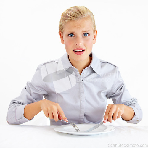 Image of Confused, hungry and woman with empty plate in studio with bored, upset or shock face. Surprise, frustrated and portrait of female person from Australia with dish and cutlery by white background.