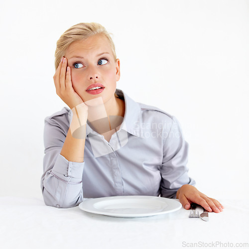 Image of Bored, upset and woman with a plate in a studio with starving, frustrated and grumpy face. Angry, hungry and young female person from Australia with dish and cutlery isolated by white background.