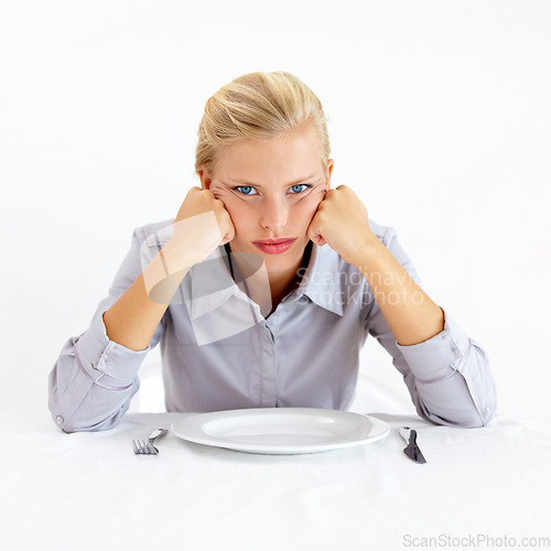 Image of Bored, portrait and woman with a plate in a studio with upset, frustrated and grumpy face. Angry, hungry and young female person from Australia with dish and cutlery isolated by white background.