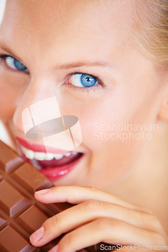 Image of Studio portrait, woman and eating chocolate slab bar, taste snack or unhealthy junk food, dessert or sugar candy. Wellness craving, closeup beauty face or person bite tasty sweets on white background