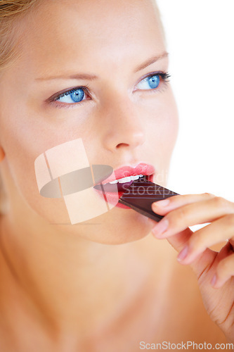 Image of Studio face, woman thinking or eating chocolate, cacao product or taste dessert snack, unhealthy junk food or candy. Wellness sweets, beauty or model brainstorming cheat meal plan on white background