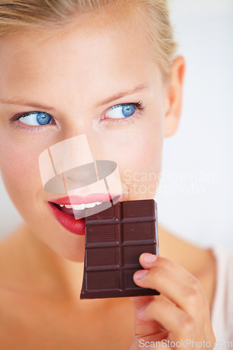 Image of Eating woman face, thinking and looking at dark chocolate benefits, antioxidants wellness or junk food. Craving solution, taste and girl planning sugar product, cacao bar or sweets advertising plan