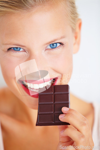 Image of Portrait, woman happiness and eating dark chocolate bar, tasty cocoa snack or unhealthy junk food, dessert or sweets. Diet craving, antioxidants benefits and model face, smile or happy for cacao slab