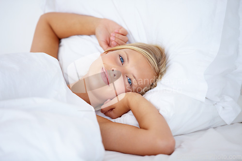 Image of Woman, portrait or waking up in home bedroom for relax, sleeping and weekend rest. Smile, face or happy person lying or stretching in house, hotel or apartment bed for comfort break in morning rotine