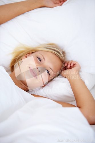 Image of Person, portrait or wake up in home bedroom for relax, sleeping and weekend rest. Smile, awake or happy woman lying or stretching in house, hotel or apartment bed for comfort break in morning rotine