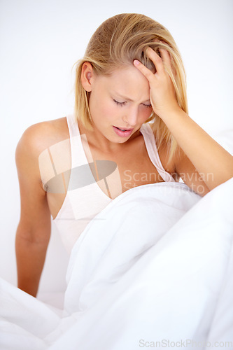 Image of Person, hangover or headache in home bedroom for morning depression, anxiety or burnout. Stress, frustrated or tired woman in house with mental health, migraine or pain from trauma, crisis or mistake