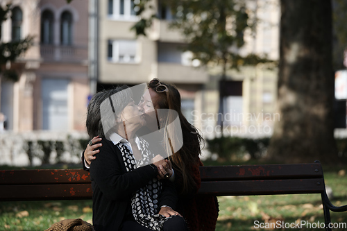 Image of Elderly old cute woman with Alzheimer's very happy and smiling when eldest daughter hugs and takes care of her